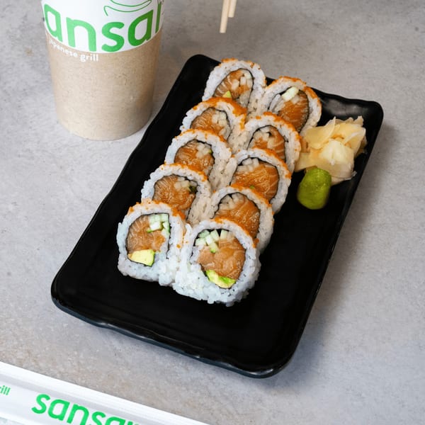 SanSai Japanese Grill sushi rolls with salmon, avocado, and cucumber, served with ginger and wasabi.