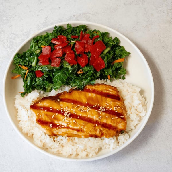 SanSai Japanese Grill's teriyaki salmon with white rice and a side of kale salad.