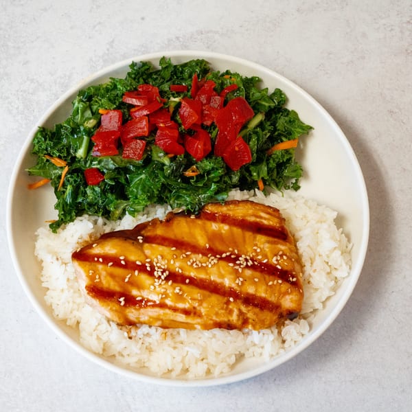 SanSai Japanese Grill's teriyaki salmon with white rice and a side of kale salad with red peppers.